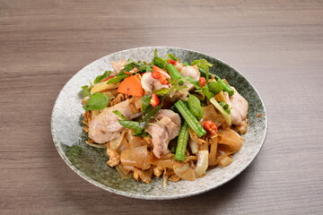 wok fried noodle phad Thai with chicken meat on wood background asian halal set lunch menu