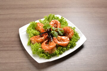 stir fried bbq tiger prawn seafood with Thai spicy chilli sweet sauce on wood background asian halal set lunch menu