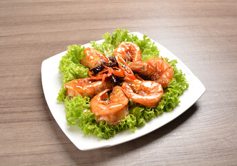stir fried bbq tiger prawn seafood with Thai spicy chilli sweet sauce on wood background asian halal set lunch menu