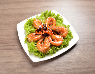 stir fried bbq tiger prawn seafood with Thai spicy chilli sweet sauce on wood background asian halal set lunch menu