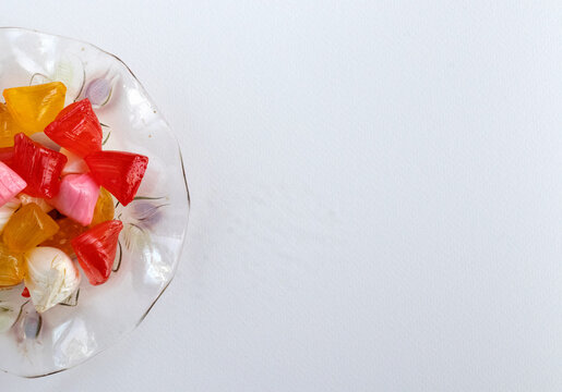 Feast concept, top view of colorful akide in glass bowl, space for copy text.