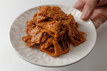 Stir-fried fish cake on white background