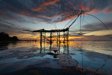 silhouette scenery of sunrise at pakpra phatthalung with thai traditional fishing trap