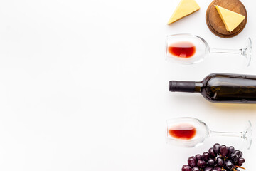 Grape and wine glasses with bottle of red wine