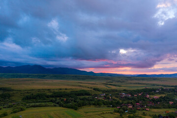 Aerial view of a storm and clouds above a village