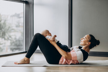 Woman with baby boy practice yoga