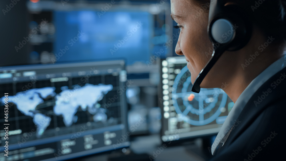 Poster Computer Screen with Global Map Technology Used by a Female Flight Controller in a Mission Control Center Room with Other Scientists. Team of Engineers Work in Monitoring Room Full of Displays.