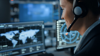 Computer Screen with Global Map Technology Used by a Female Flight Controller in a Mission Control...