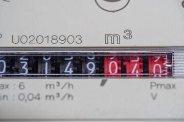 A closeup view of the dial or face of a metric gas meter in home