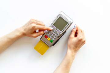 Hand swiping credit card by pos terminal. Payment transactions concept