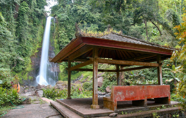Gitgit warefall in Buleleng regency of Bali Indonesia,with smooth white water and traditional waiting pavilon as a forground