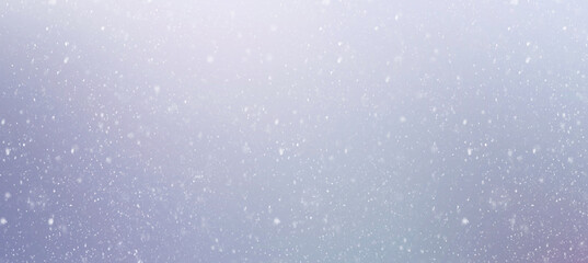 Abstract Christmas background with snowflakes during snowfall on blurred background