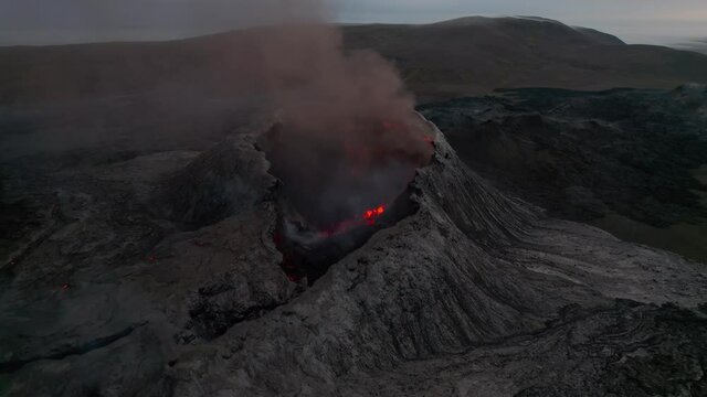 Smoking volcano crater Iceland aerial pan