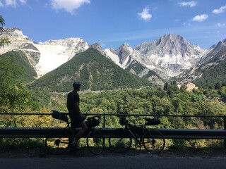person on a bench in mountains