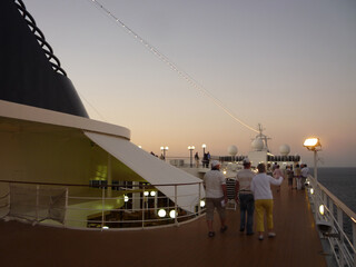 Outdoor sun or pool deck with chairs, loungers and other seating of modern MSC cruiseship cruise...