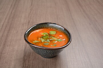 Thai tomyum seafood meat hot soup with spicy chilli sauce on wood table asian halal menu