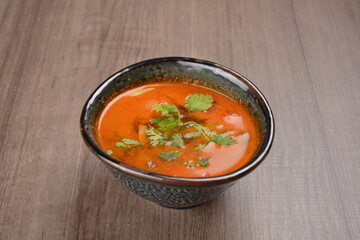 Thai tomyum seafood meat hot soup with spicy chilli sauce on wood table asian halal menu