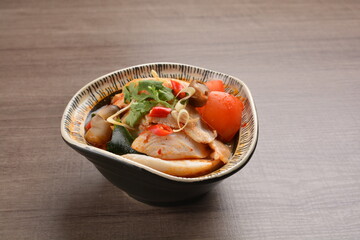 Thai tomyum seafood meat hot soup with spicy chilli sauce on wood table asian halal menu