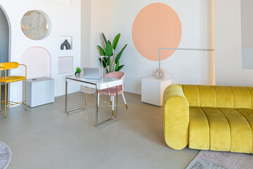 modern open-plan room interior in futuristic style in pastel colors with graphic wall decoration. very high ceilings and a huge window. soft stylish furniture with gold metallic elements