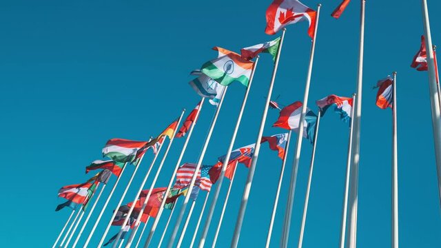 Different flags fluttering on flagpoles