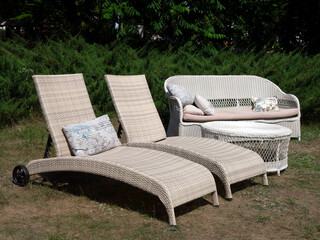 Two outdoor chaise lounge chairs, sofa and table. Garden furniture. Outdoor furniture set