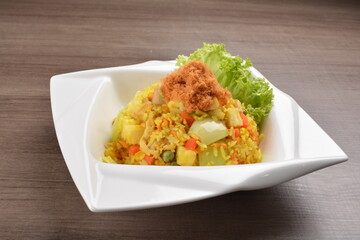 Thai golden pineapple wok fried rice with chicken floss on wood table asian halal menu