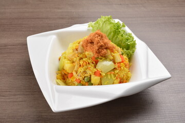 Thai golden pineapple wok fried rice with chicken floss on wood table asian halal menu