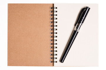 Top view of spiral kraft notebook front, open page on background