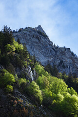 The snow-capped mountains of Val Masino, during spring in the Italian Alps, near the town of San Martino, Italy - May 2021.