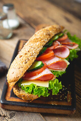 Large sandwich with ham, cheese and vegetables