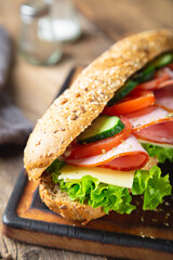 Large sandwich with ham, cheese and vegetables