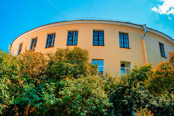 Courtyard in St. Petersburg in summer in sunny weather. A beautiful round yellow building