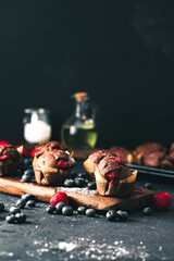 Muffin. Chocolate muffins with stawberry. Muffins on wooden stand. - obrazy, fototapety, plakaty