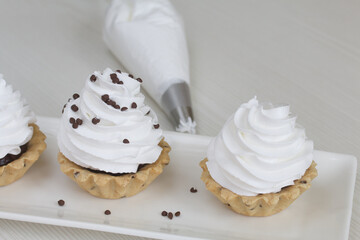 Cake Basket. With chocolate and cream. Lies on a plate. Close-up shot.