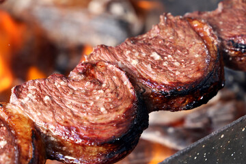 Picanha. Traditional Steak beef in Brazilian barbecue with fire background