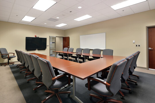 Office Conference Board Room With Long U-shaped Desk And Tv Screen