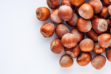 fresh natural hazelnuts on a white acrylic background