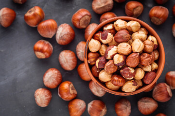 fresh natural hazelnuts on a dark stone background