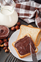 toasts with chocolate butter on a dark wooden rustic background