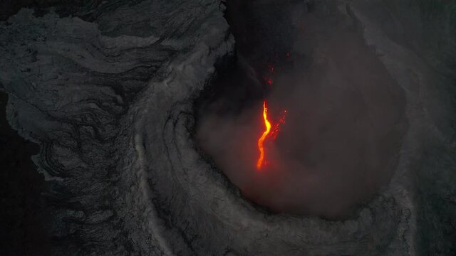 Looking down over smoking volcano crater Iceland static aerial