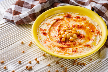 traditional turkish hummus on a white wooden rustic background