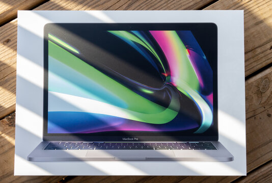 Washington, DC US -  April 02, 2021: Unopened brand new Apple silicon MacBook Pro 13 inch retina screen m1 chip model in retail packaging with 16 core neural engine and 8gb shared system memory RAM