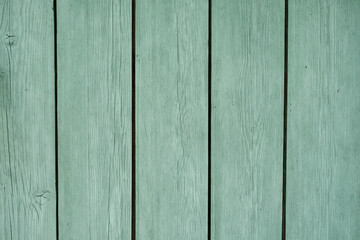 Natural wooden background made of boards painted in mint color. Paint for wooden surfaces