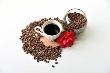 Coffee, rose and coffee beans on a white background