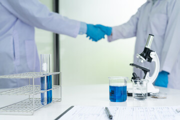 A scientist wearing medical isolation gown investigating the growth, structure development, and...