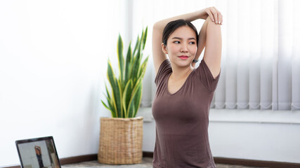 A calm woman having concentration to do yoga in a peaceful living room