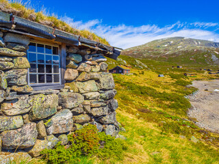 Fototapeta na wymiar Vavatn lake panorama landscape cottages huts snowy mountains Hemsedal Norway.