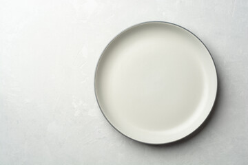 Empty plate on grey concrete background