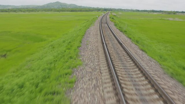Empty straight one-way railways on a summer sunny day