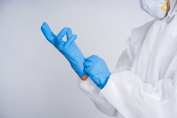 Fototapeta premium Close up of hands putting on medical gloves